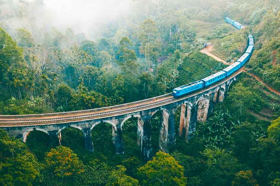 arial view of nine arch bridge while a train on it. located in demodara near ella
