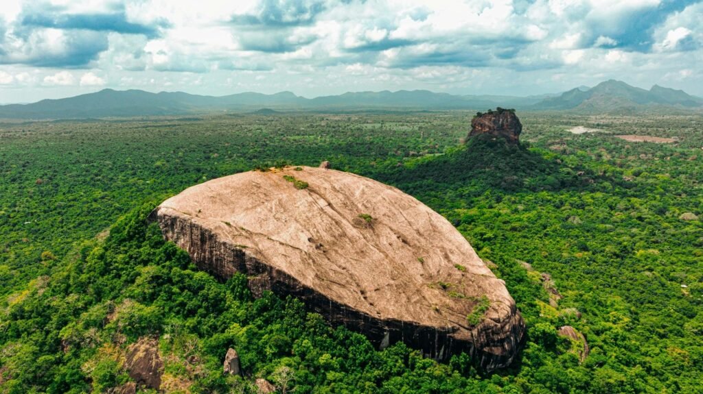 drone shot of pidurangala rock with sigiriya rock visible in the background